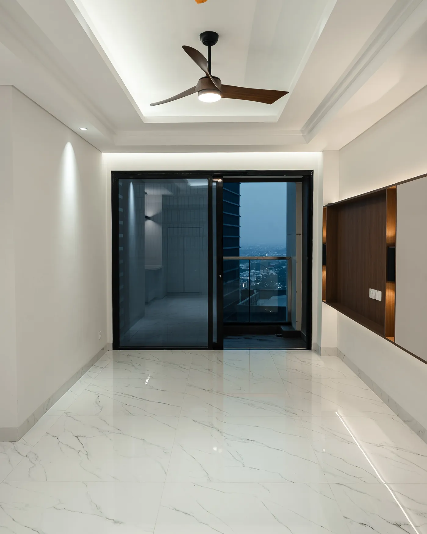 Living area in neutral tones opening to a balcony