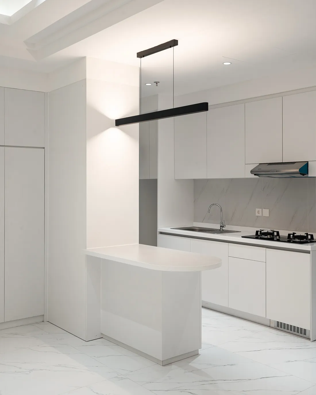 White kitchen with an island added to the existing layout